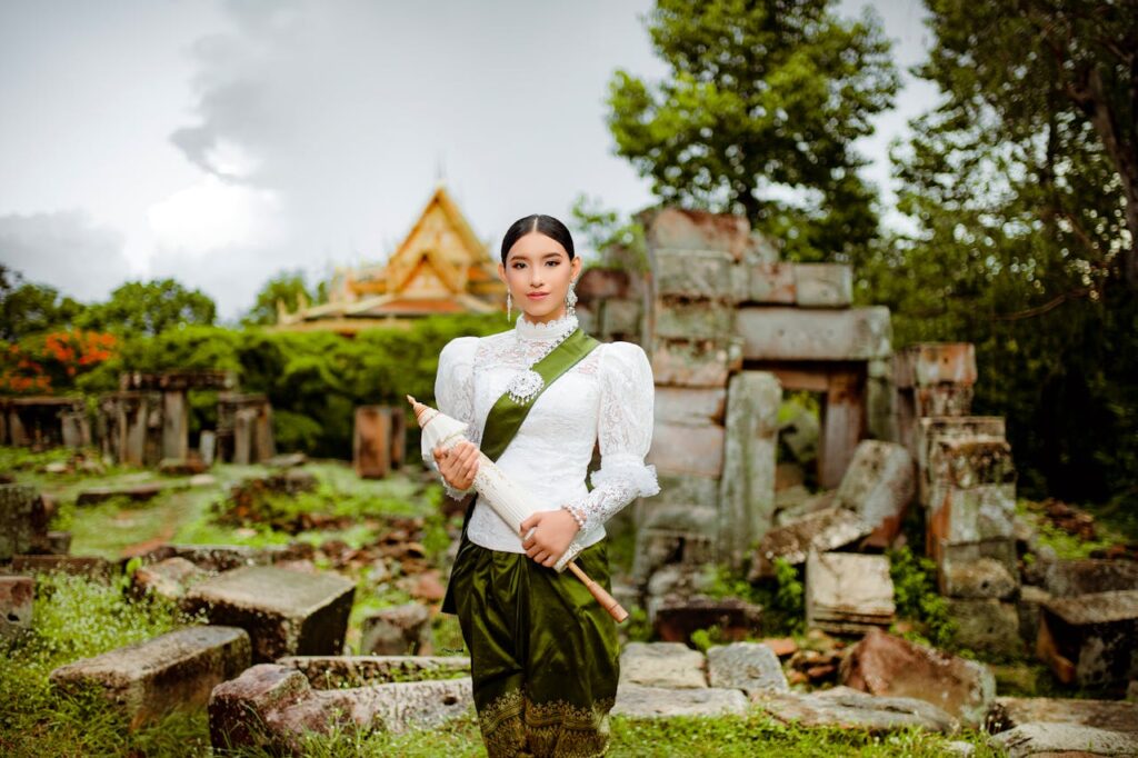 Cambodia Travel Insurance - Woman in elegant traditional costume againts Ruins of Angkor Wat Cambodia Travel Insurance - Woman in elegant traditional costume againts Ruins of Angkor Wat